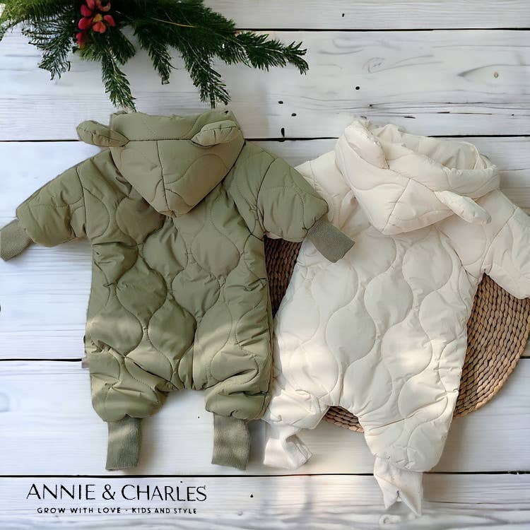 Children's quilted outfit and blanket on a wooden surface with 'Annie & Charles' branding.