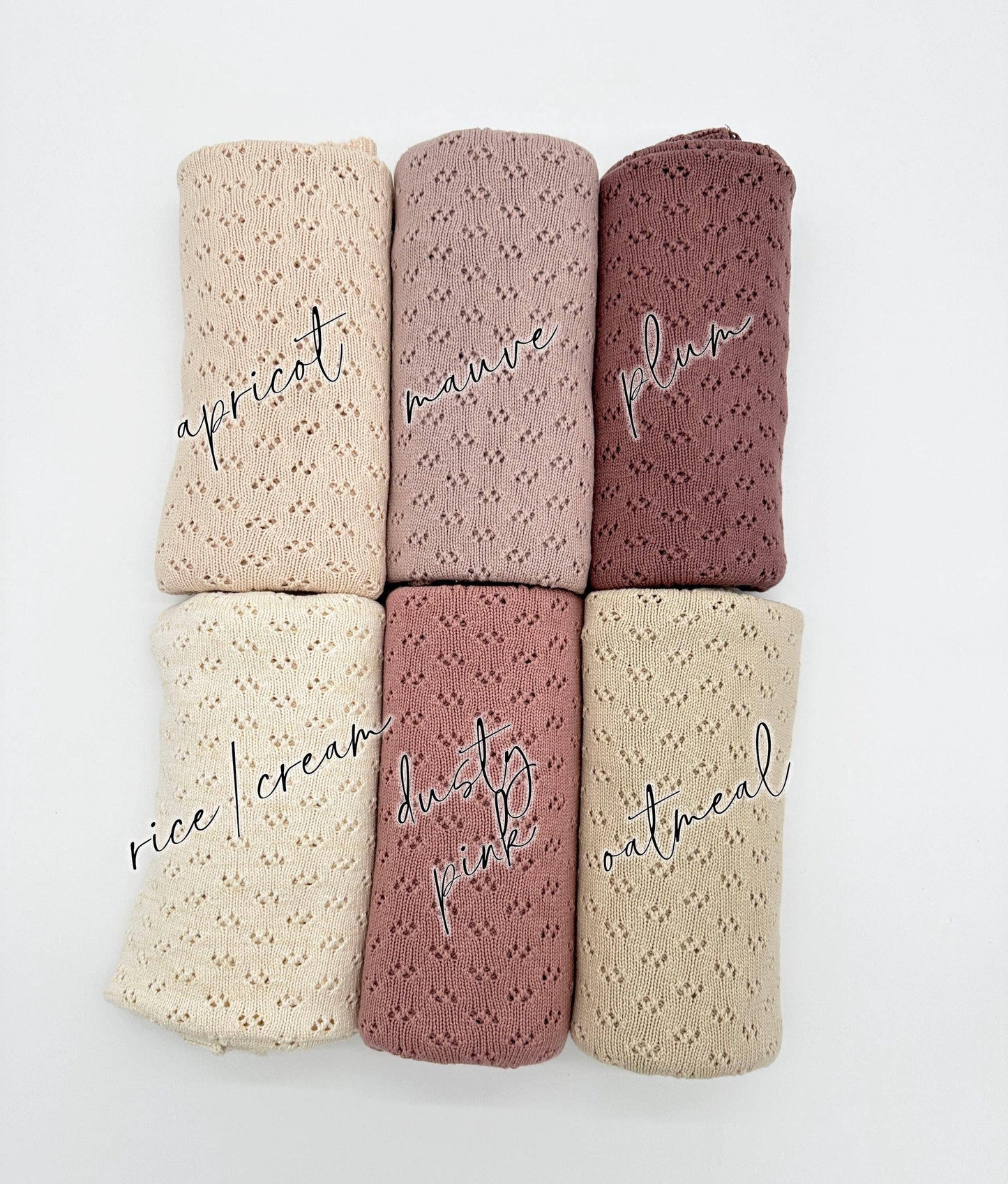 Set of five folded fabrics in different colors with text labels on a white background