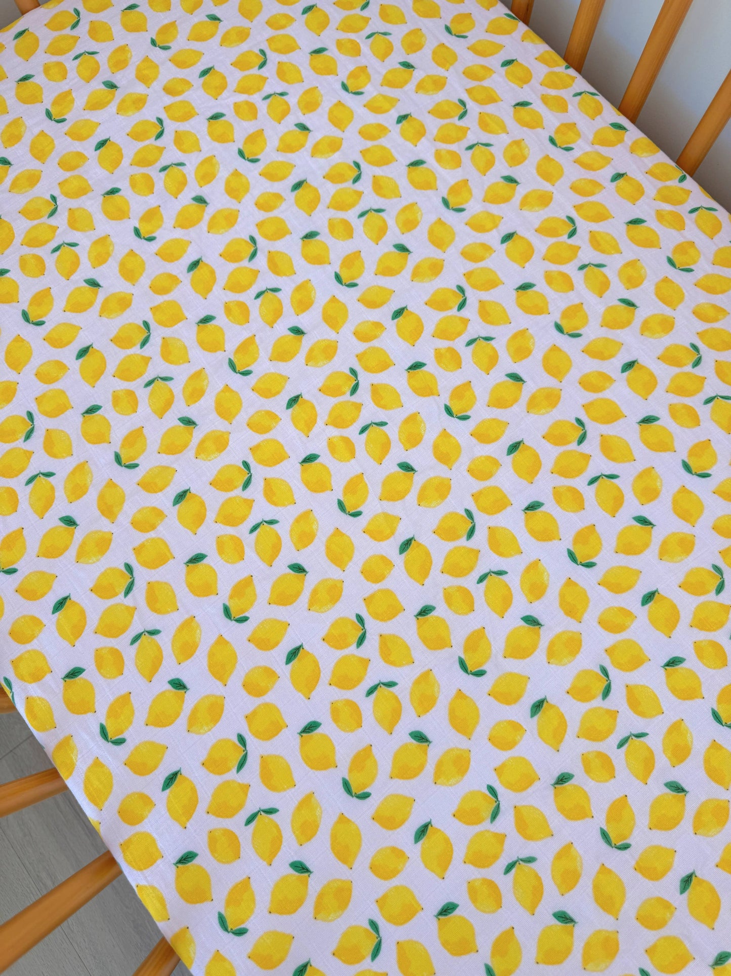 Tablecloth with lemon pattern on a wooden table