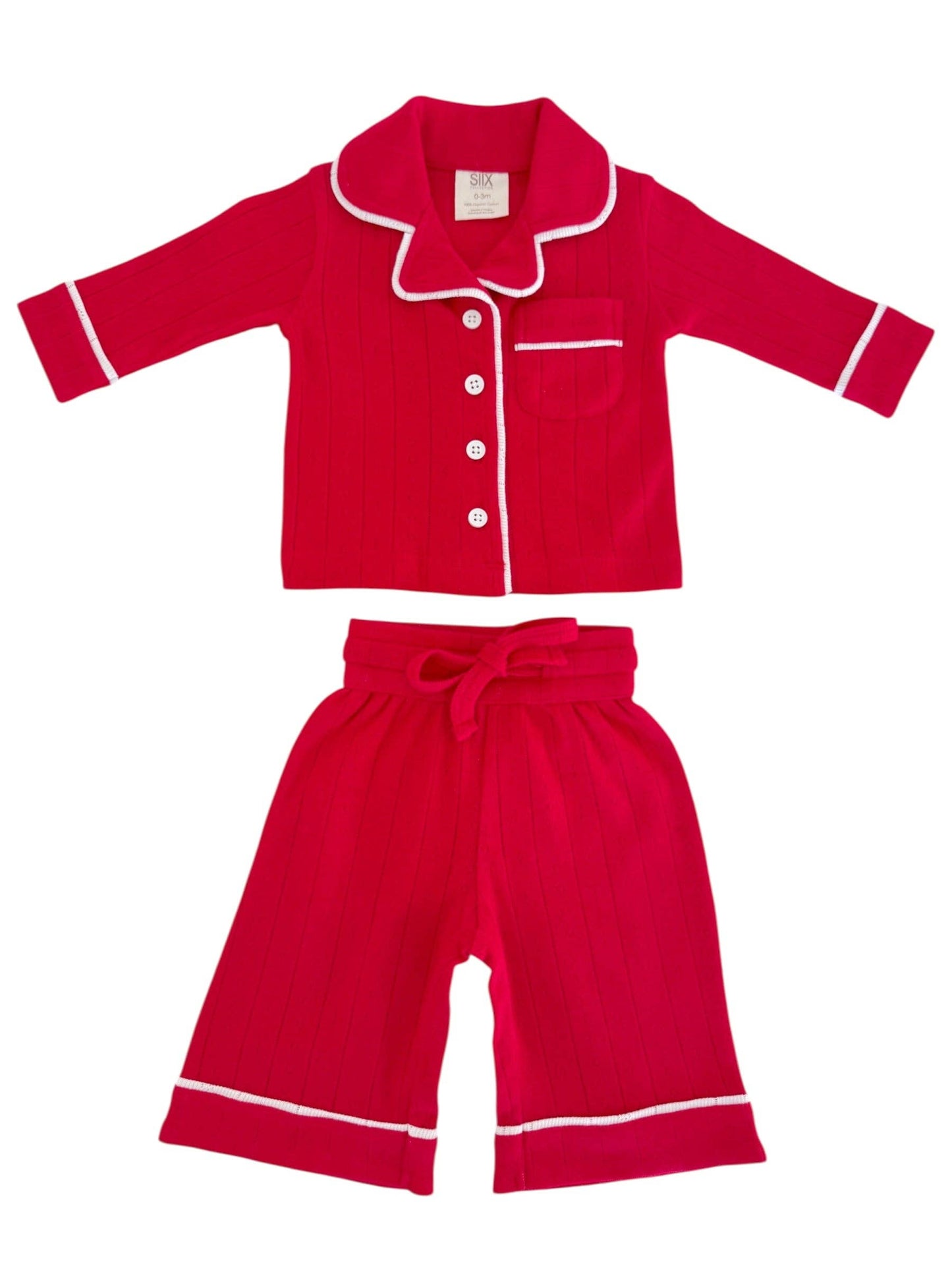 Red children's pajama set with white buttons and trim on a white background