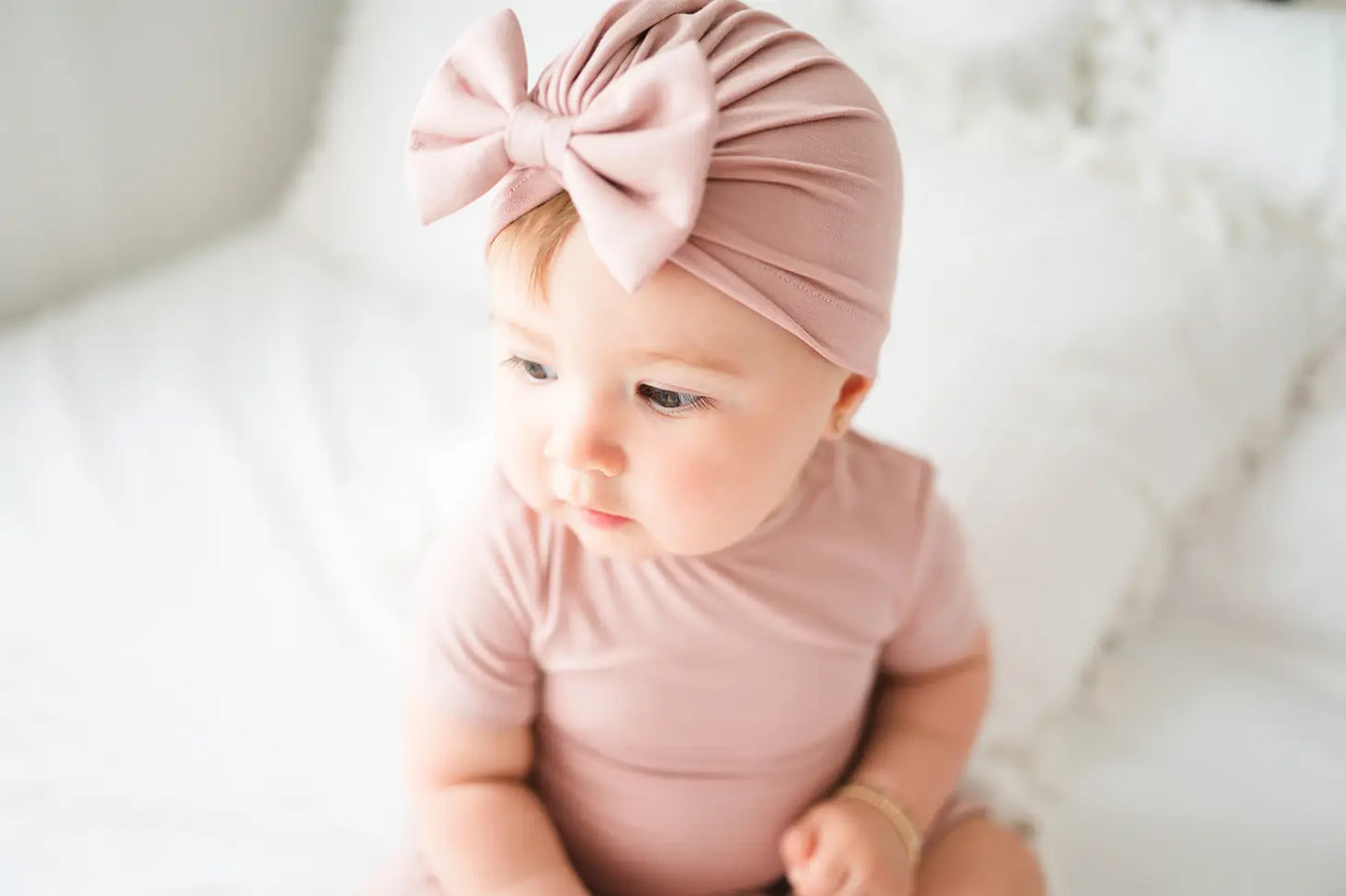 Baby wearing dusty pink turbie