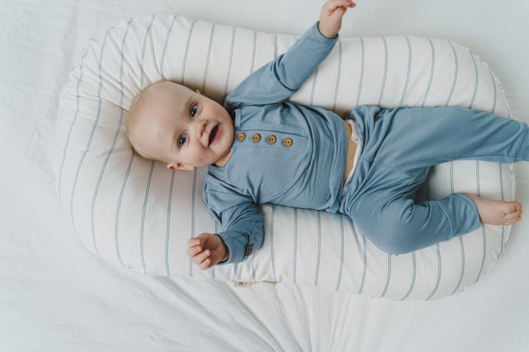 Baby wearing blue top and bottom set in a lounger