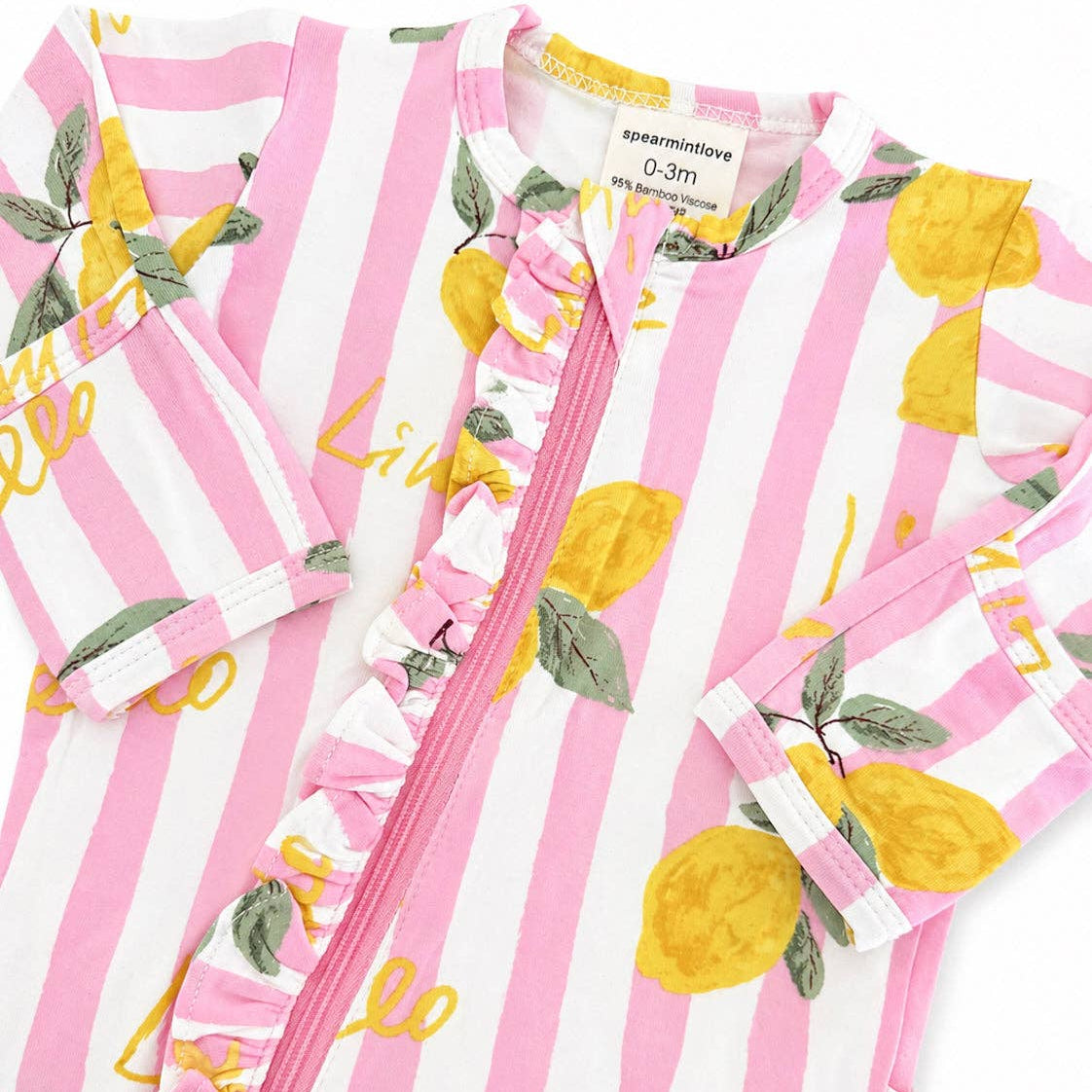 Pink and white striped baby romper with lemon designs on a white background