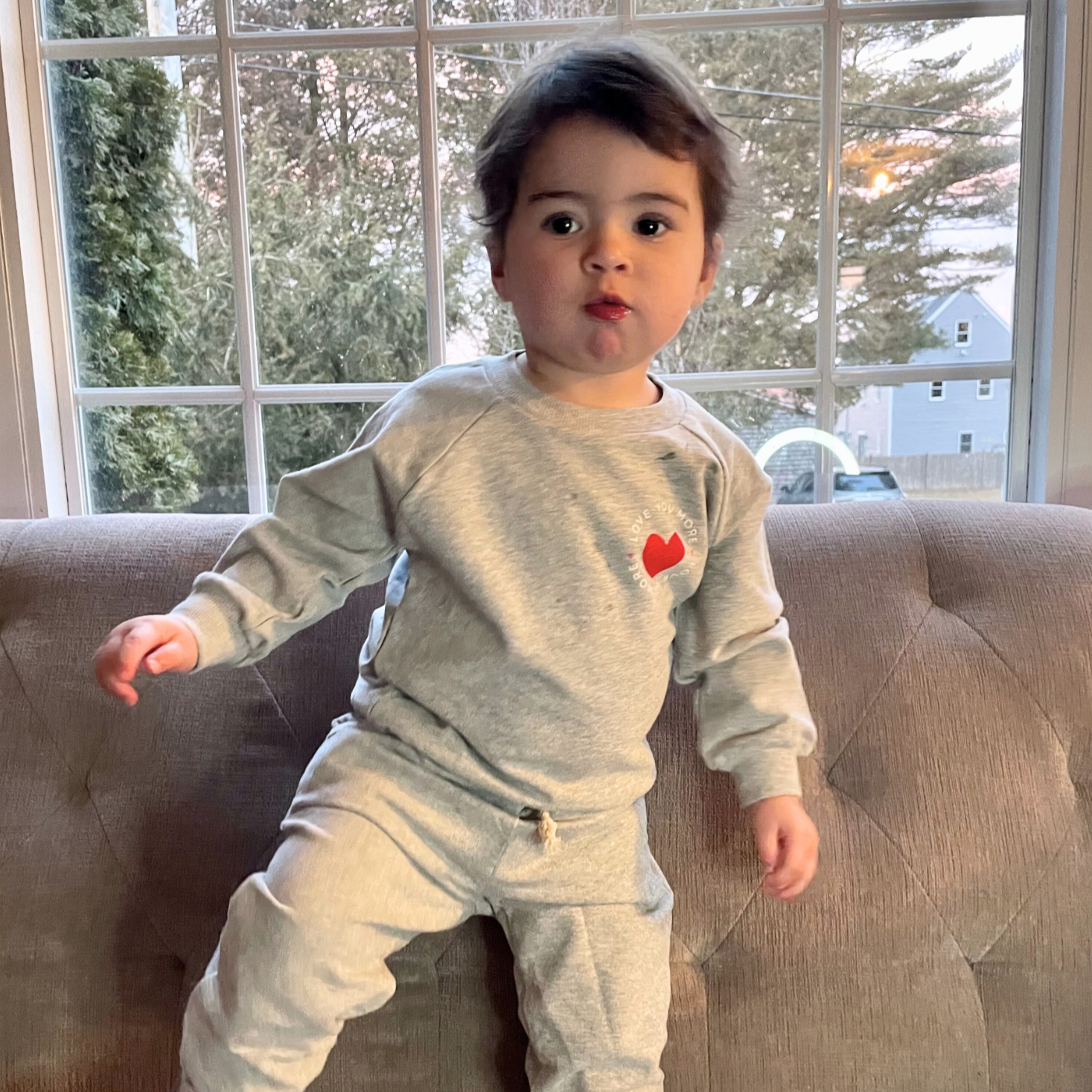 toddler in gray "love you more" sweatsuit