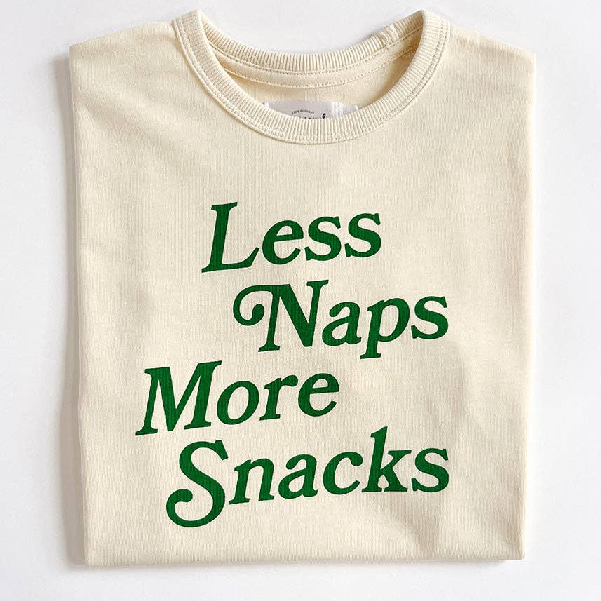 Natural colored shirt with green text 'Less Naps More Snacks' on a white background