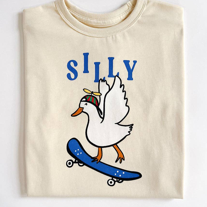 Beige sweatshirt with a cartoon duck on a skateboard and the word 'SILLY' above it on a white background.