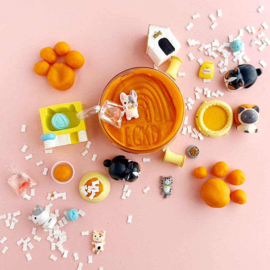 Colorful playset with toys and a cup on a pink background