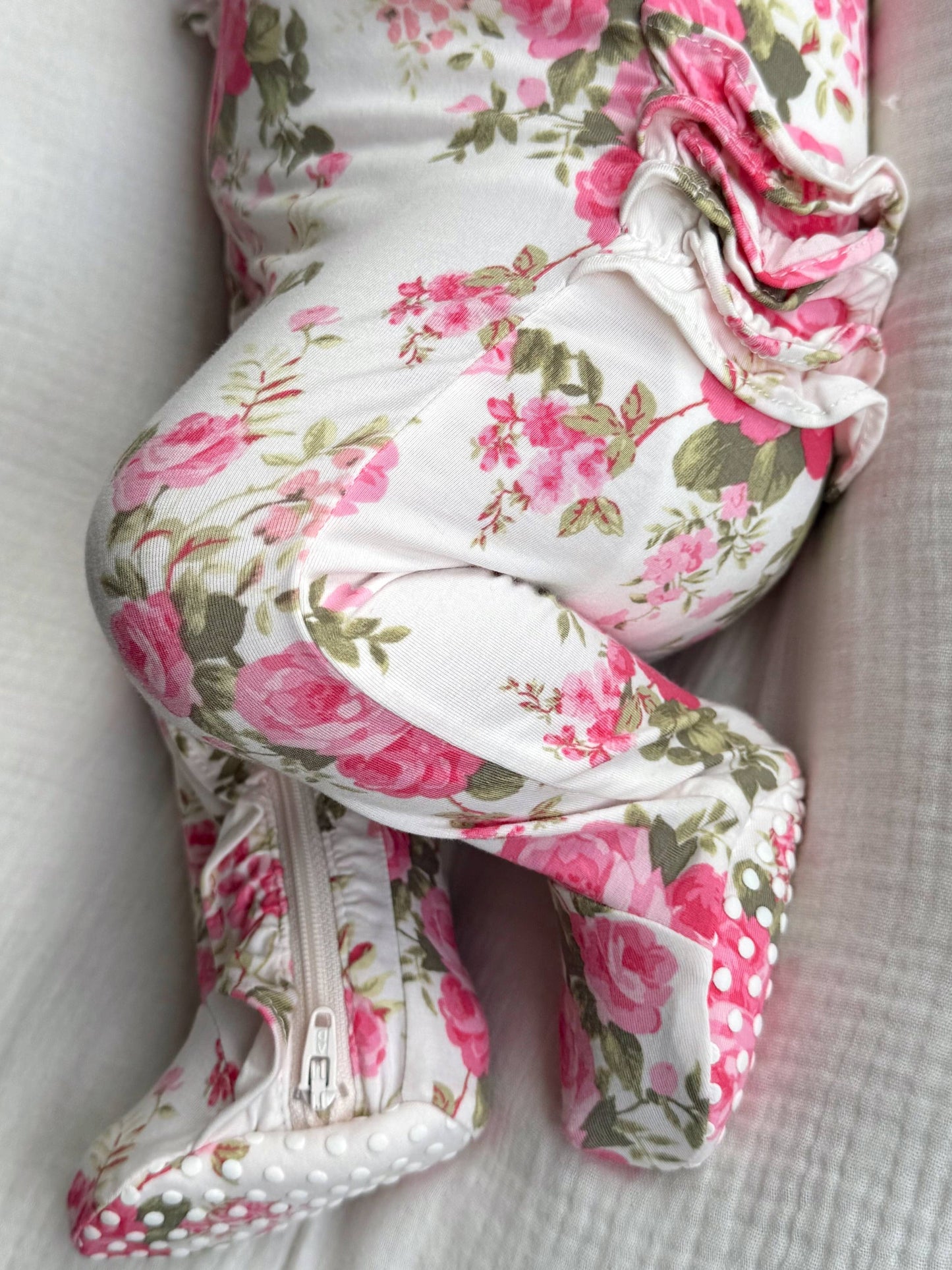Floral-patterned baby carrier on a white background