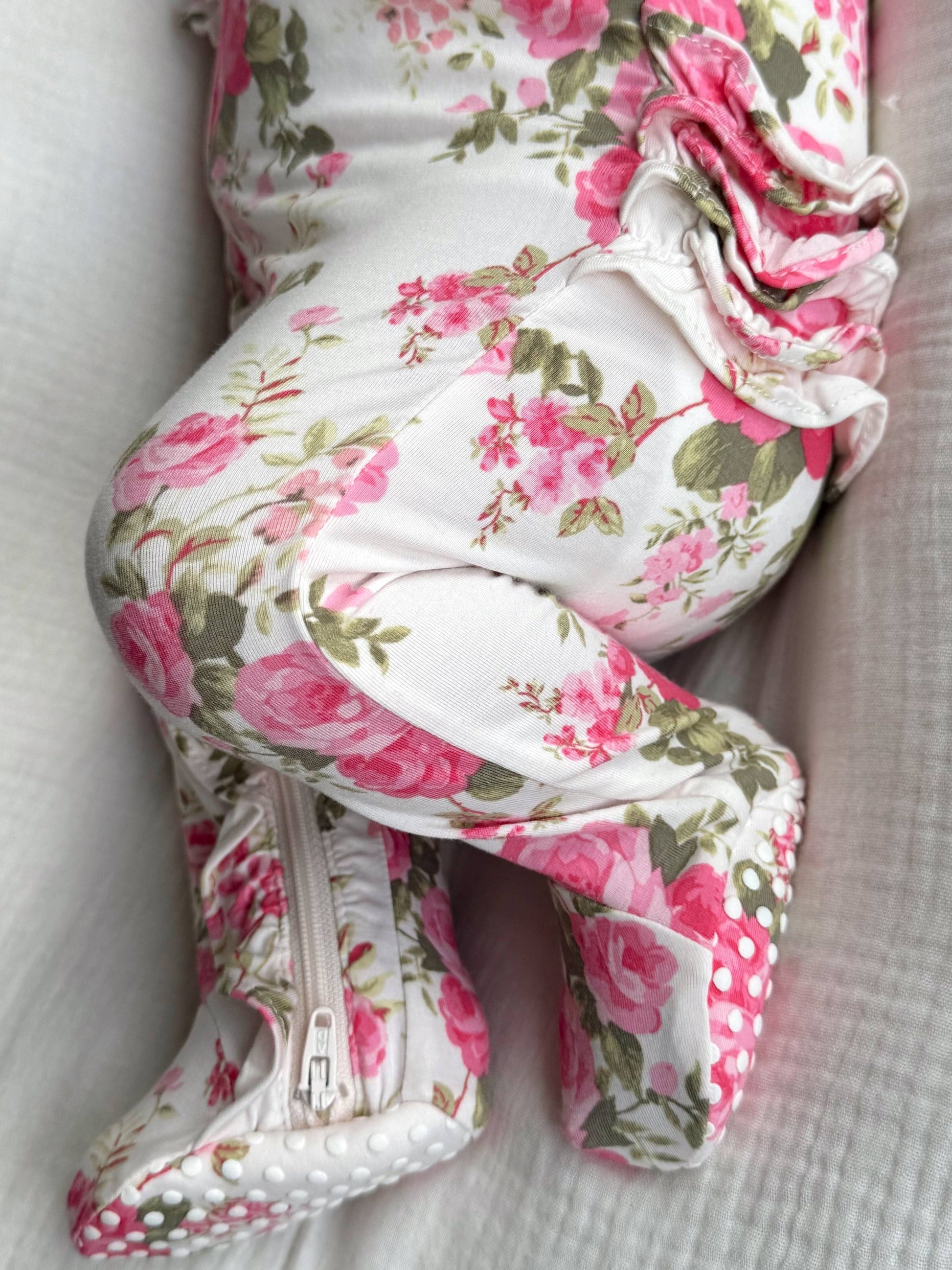 Floral-patterned baby carrier on a white background