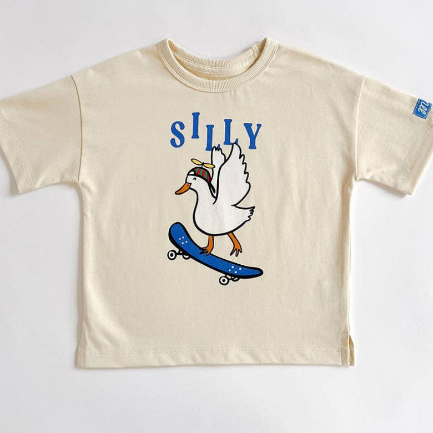 Beige t-shirt with a cartoon duck on a skateboard and 'SILLY' text on a white background