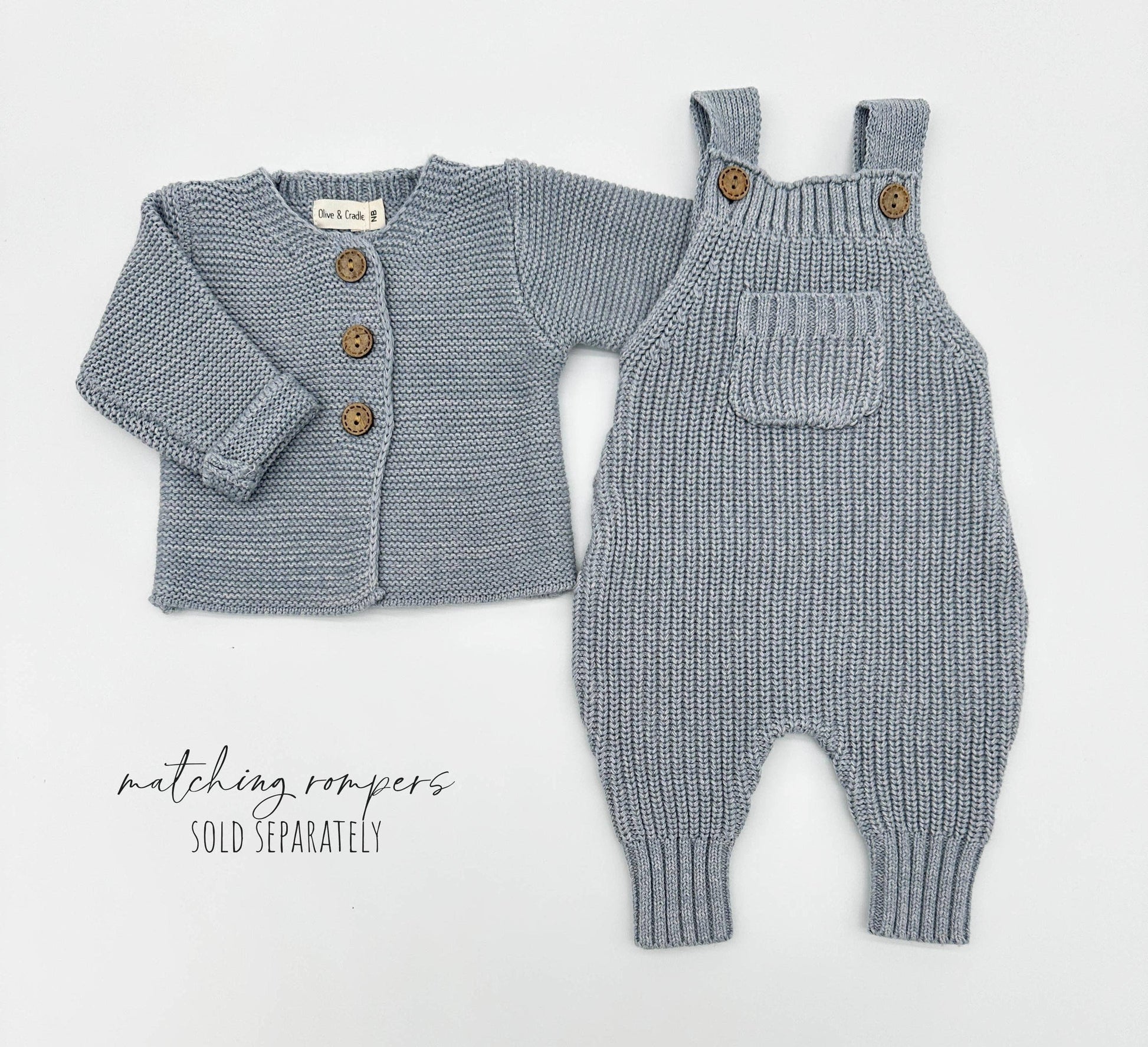 Knitted baby cardigan and romper set on a white background
