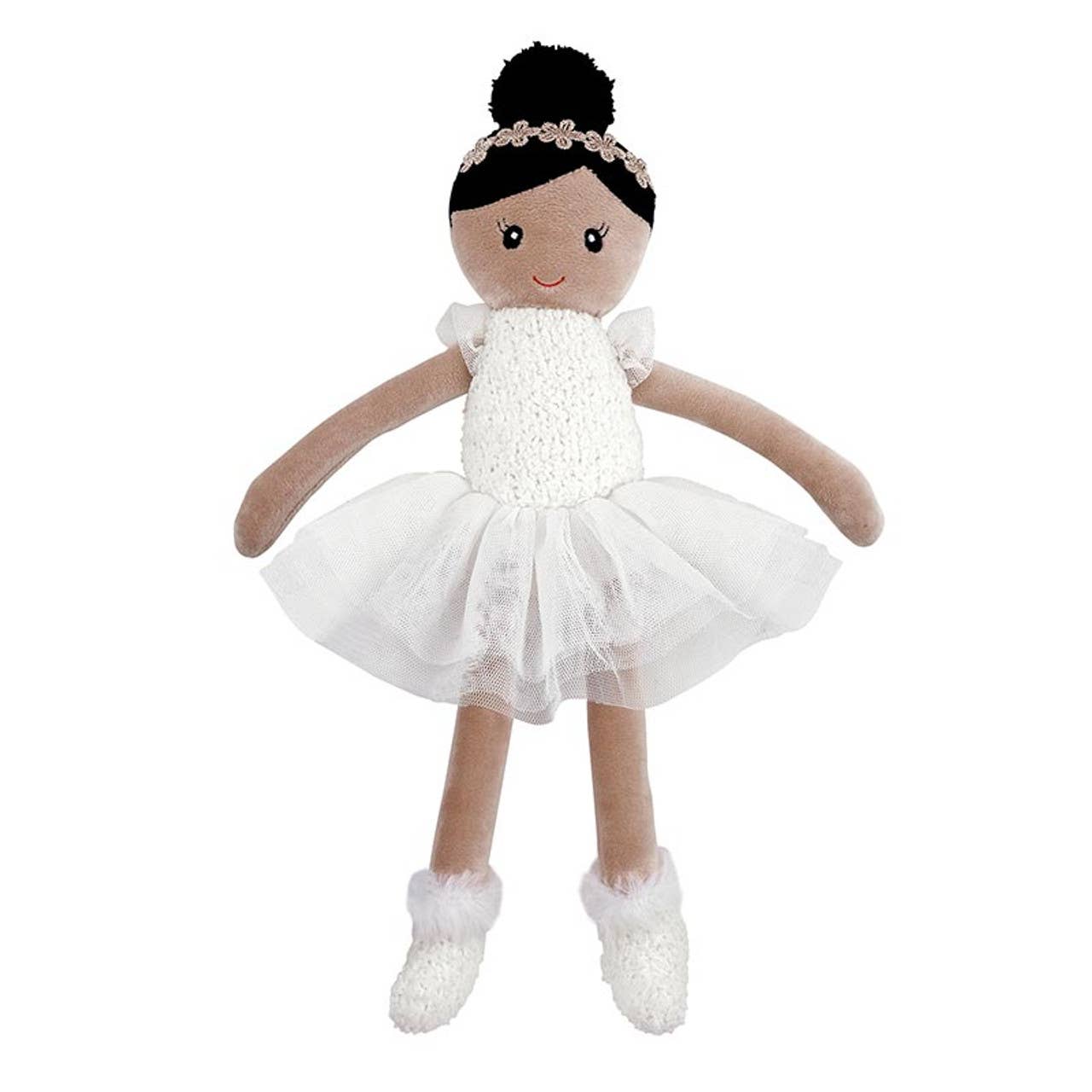 Doll in a white dress with a black bun on a white background