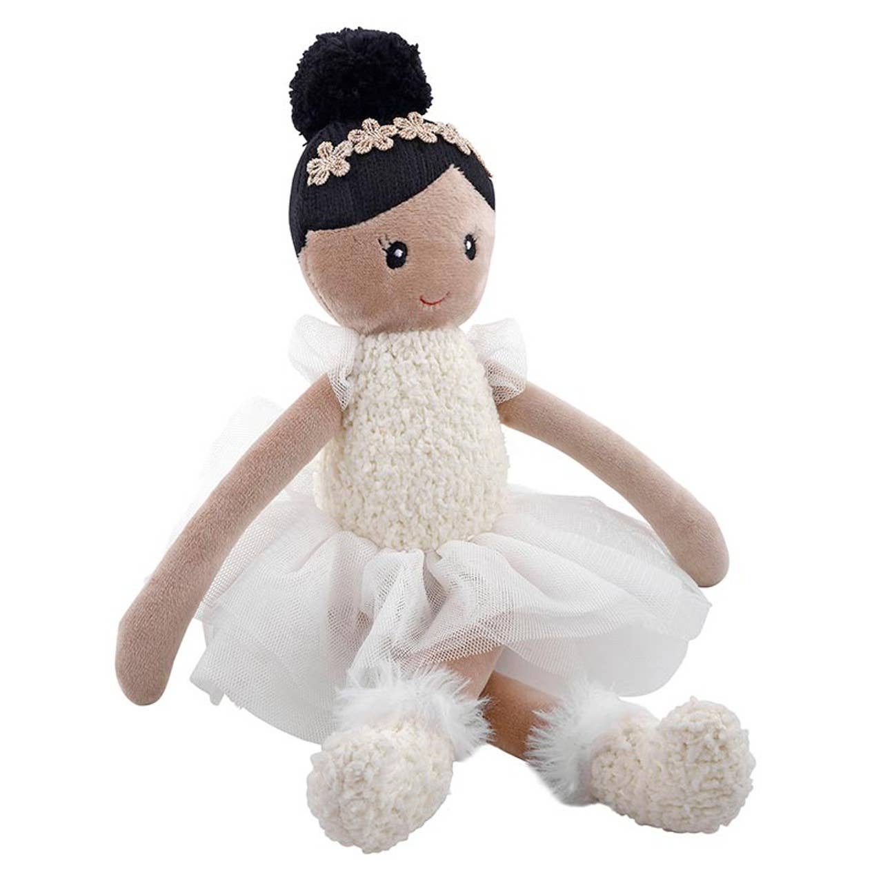Toy doll in a ballerina outfit with a white tutu and black hair accessory on a white background
