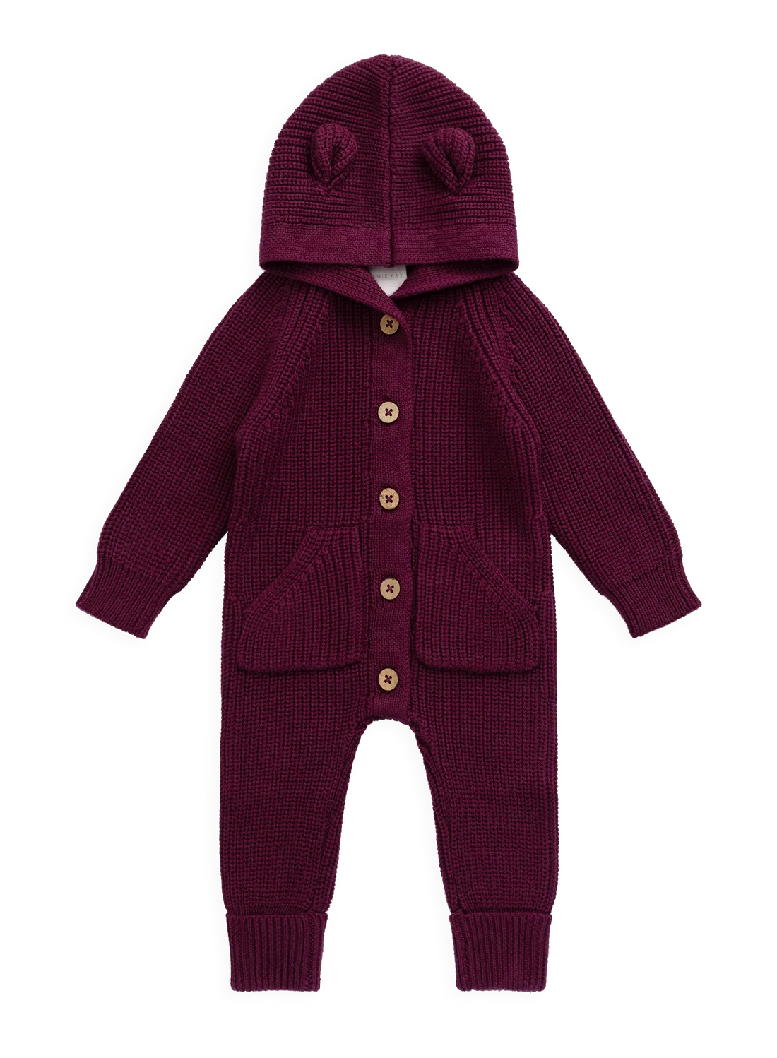 A baby knit jumpsuit in deep burgundy with a hood featuring two pom-pom ears, front button closure, and front pockets, shown on a plain white background.