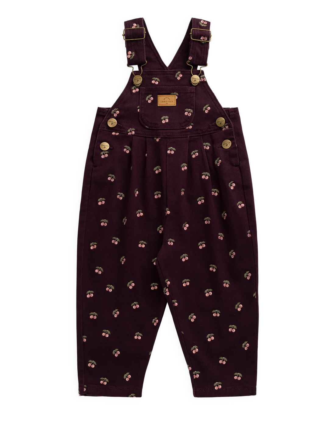 A pair of toddler boy's dark plum purple bib overalls with a small repeating pattern of cherries, featuring adjustable shoulder straps, brass-tone snap buttons, and a small tan brand patch on the chest.