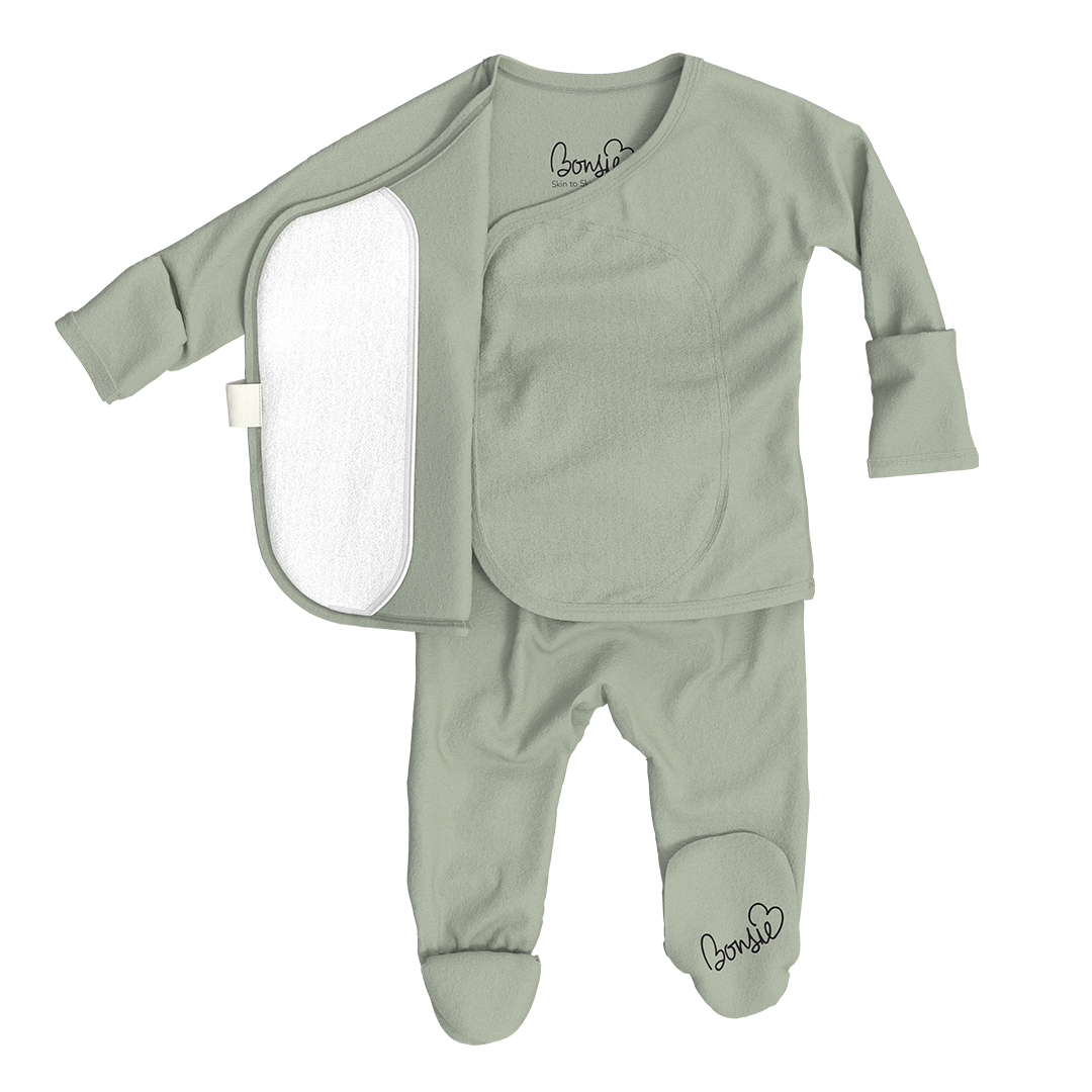 Green baby outfit with a shirt and pants on a white background