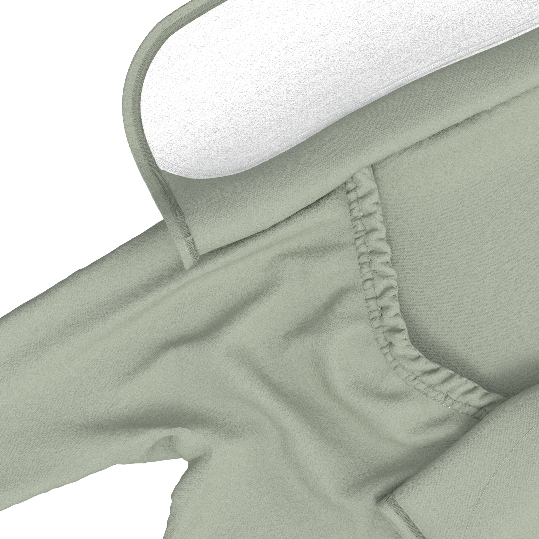 Light green pants on a hanger against a white background