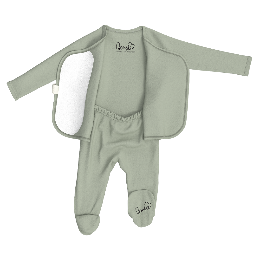 Green baby outfit with jacket and pants on a white background