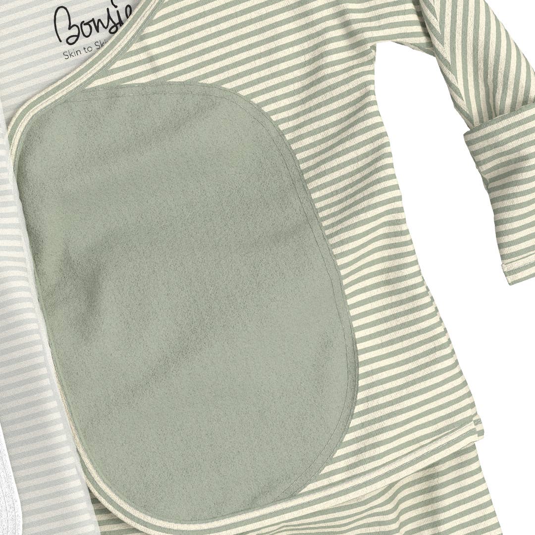 Baby outfit with green bib and striped sleeves on a white background