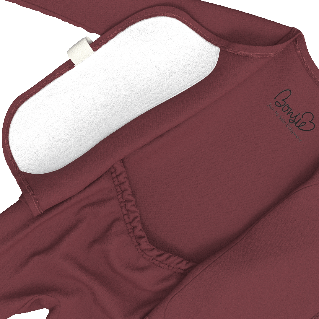 Close-up of a burgundy long-sleeve top with a white underwire bra insert, elasticized neckline, and a small black script logo on the chest.