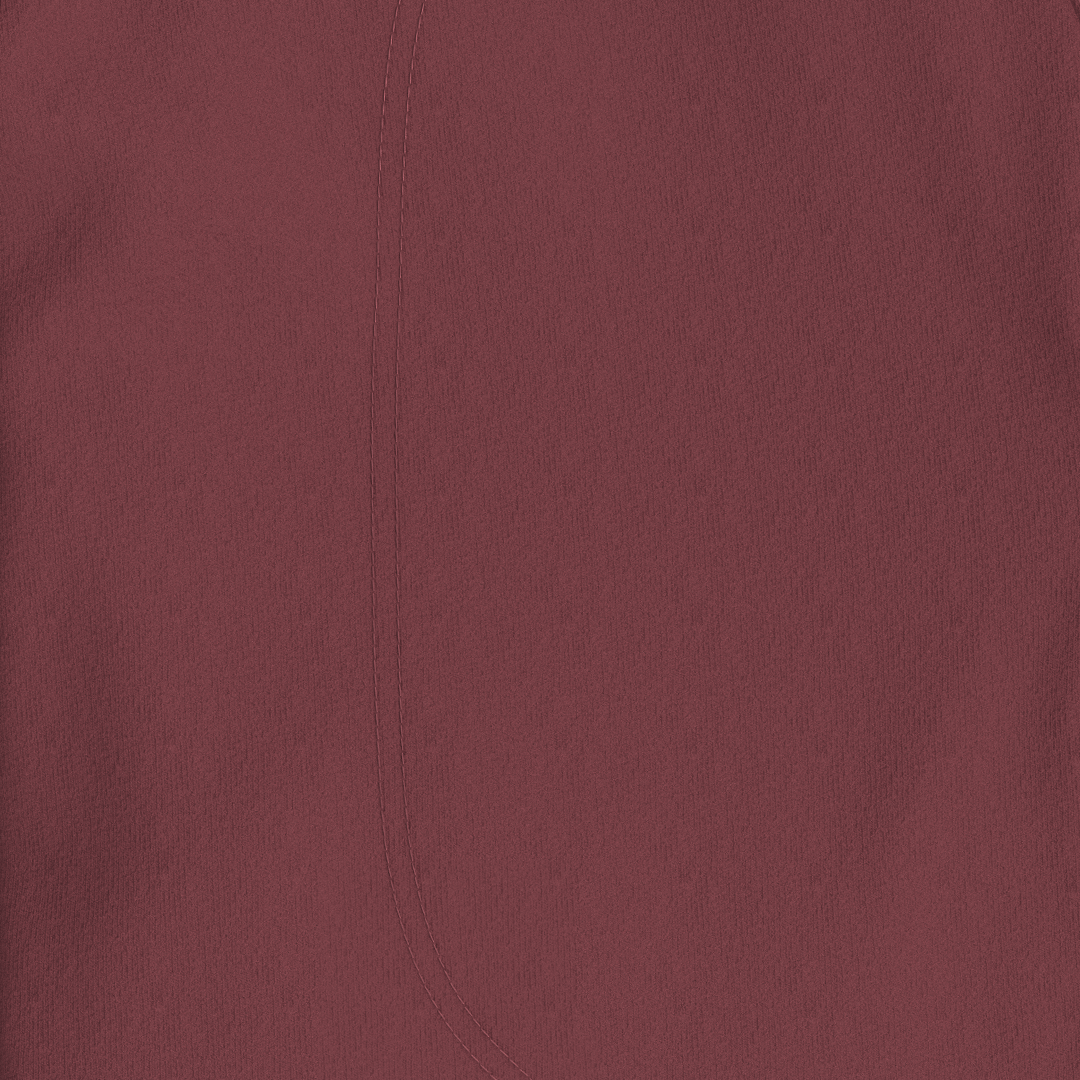 A close-up of a solid dusty rose or mauve-colored fabric texture with a fine vertical seam.