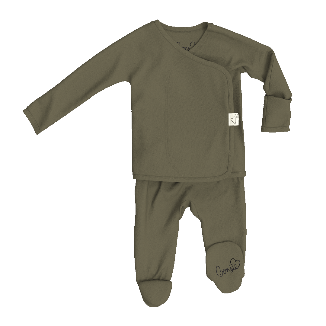 A baby sleepwear set in olive green, featuring a long-sleeve asymmetrical top and matching footed pants, shown on a plain white background.