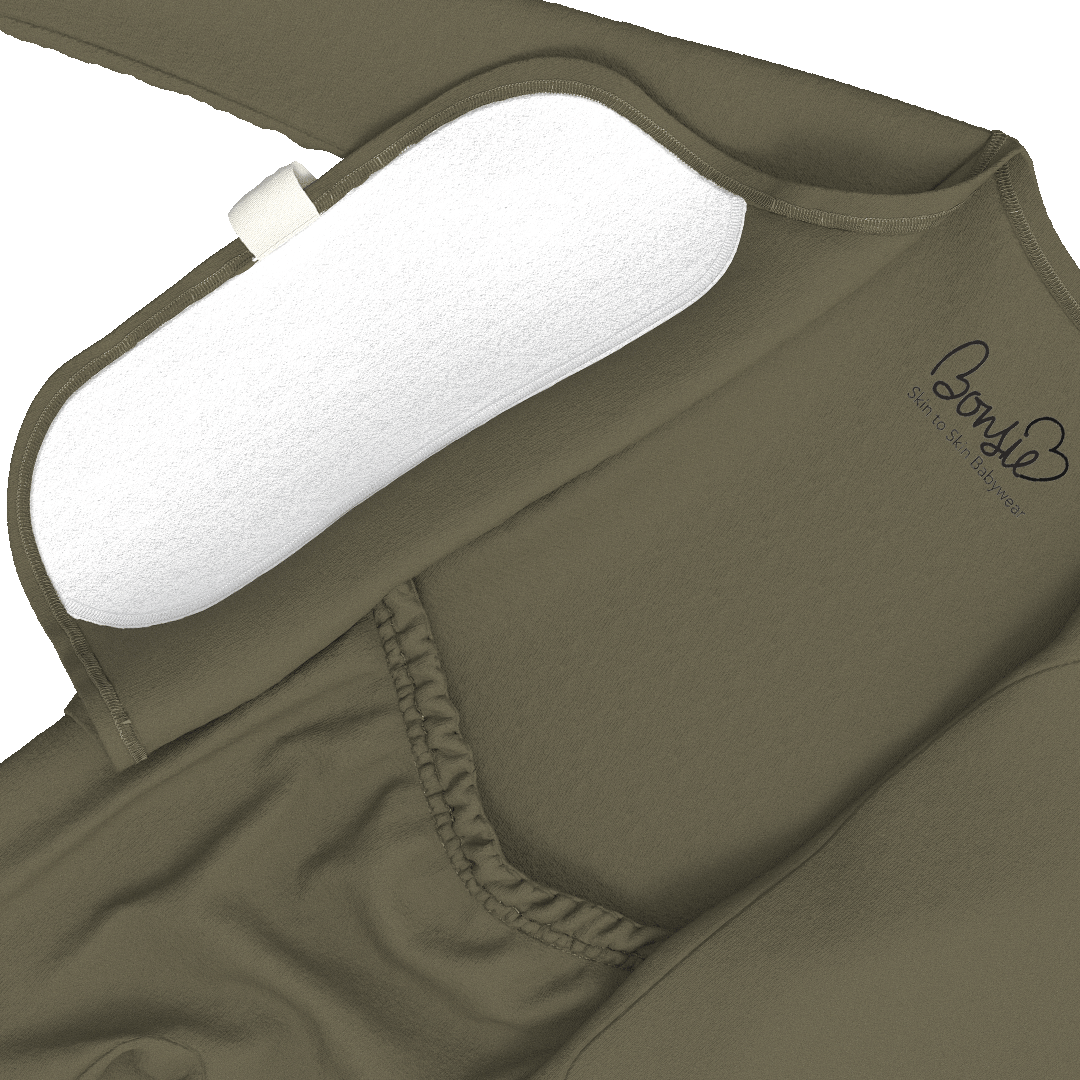 Close-up of an olive green maternity support band with a white padded insert, showing the brand logo 'Bonnie' printed on the side.