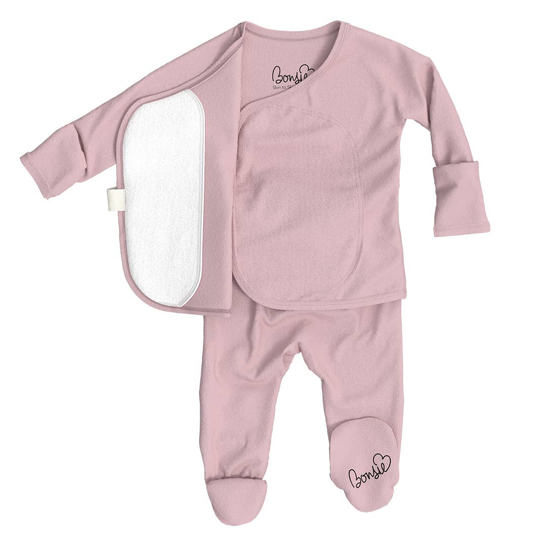 Pink baby outfit with a white patch on a white background