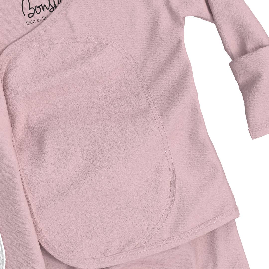 Close-up of a pink fleece garment with a brand logo on a white background