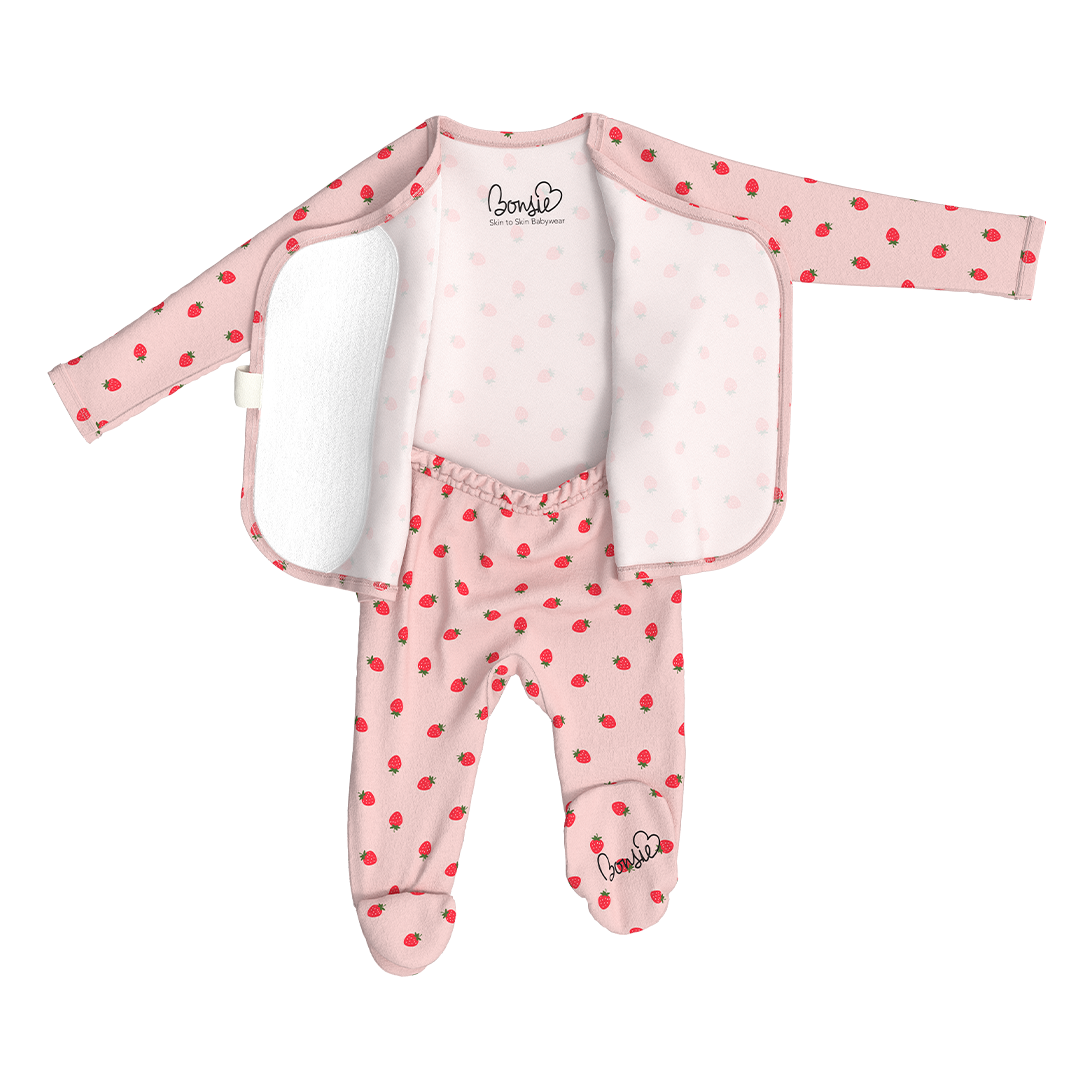 Baby outfit with pink polka dot jacket, white shirt, and pink polka dot pants on a white background