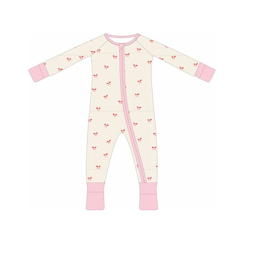 A bamboo baby sleeper with a double zipper and decorative bows on the sleeves and feet.