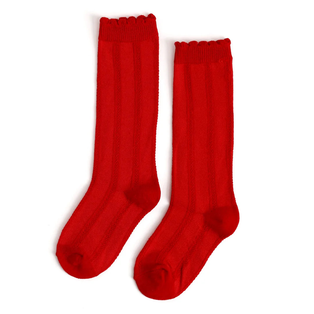 Pair of red knee-high socks on a white background