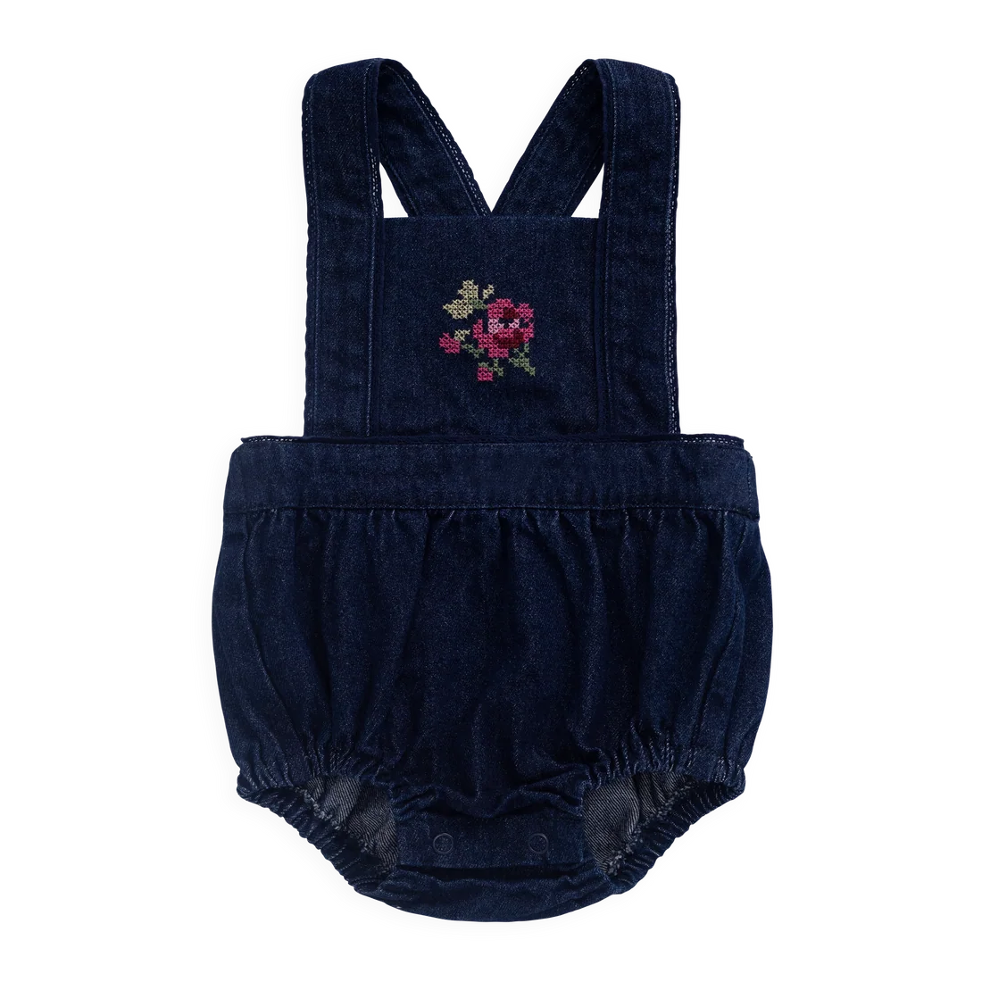 A baby romper in dark navy blue corduroy fabric with adjustable shoulder straps, a ruffled waist, and an embroidered floral motif on the chest.