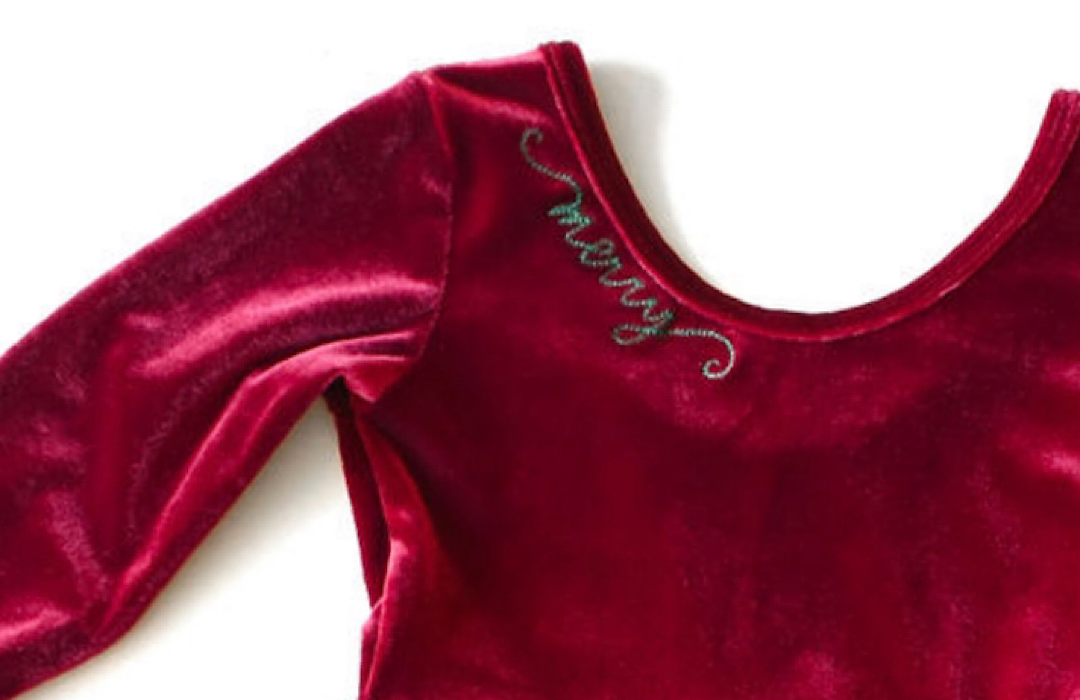 Red velvet garment with 'Merry' embroidery on a white background