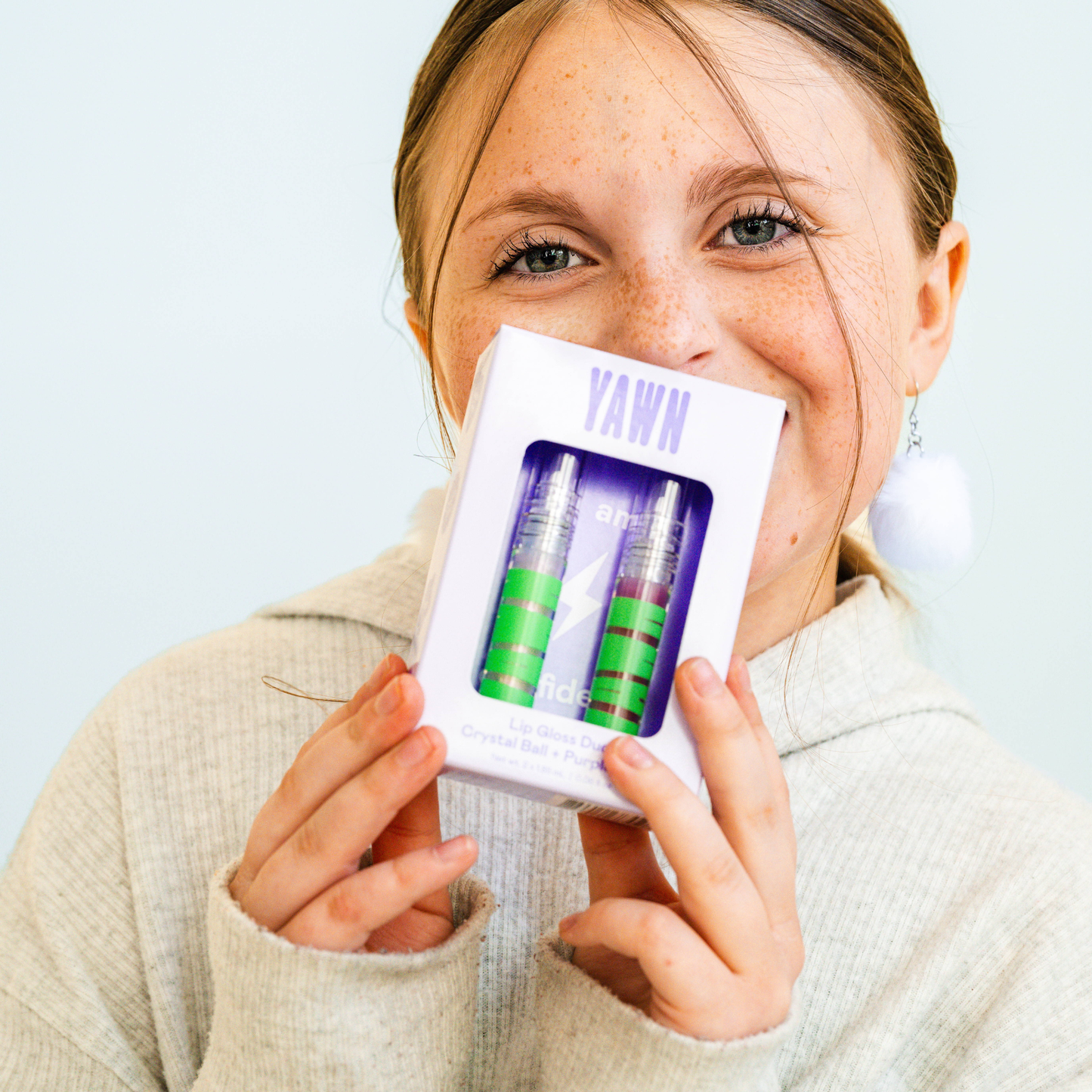 Person holding a product packaging with 'YAWN' branding