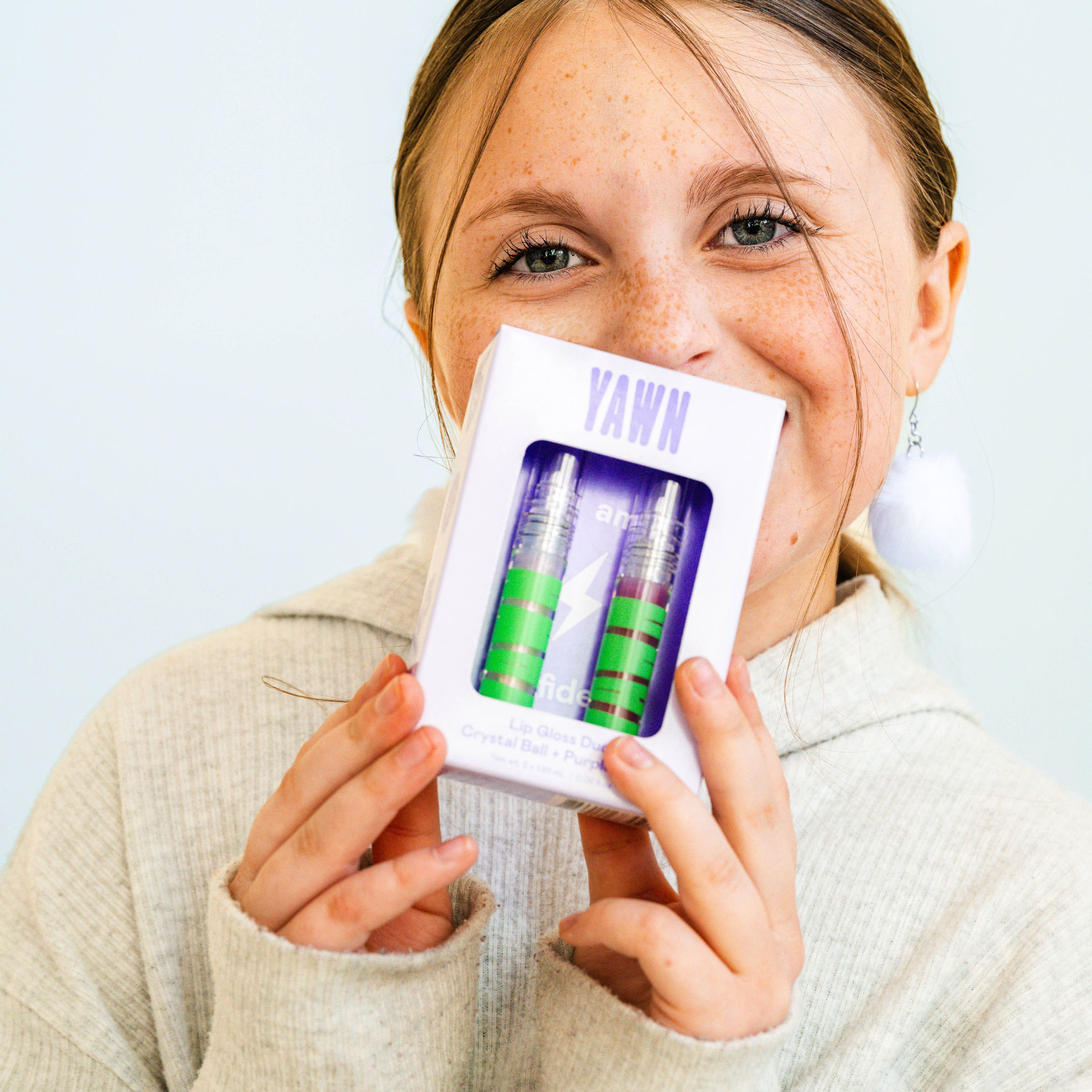 Person holding a product packaging with 'YAWN' branding