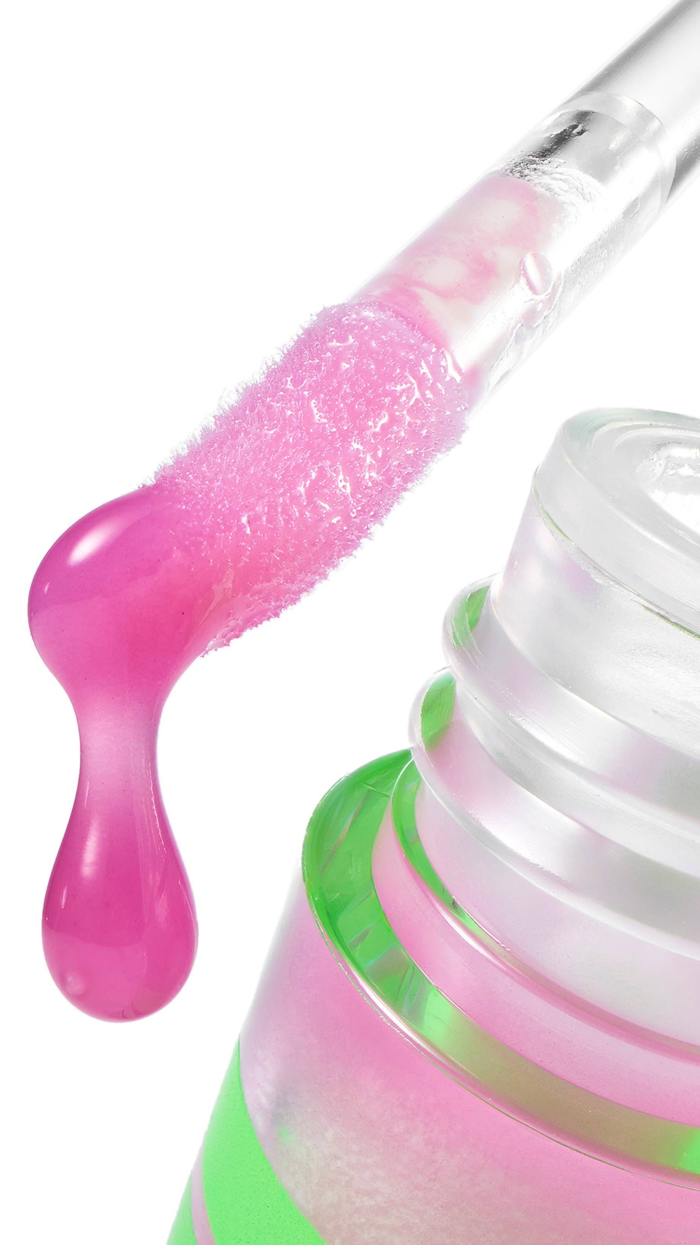 Close-up of a nail polish bottle with pink gel being applied