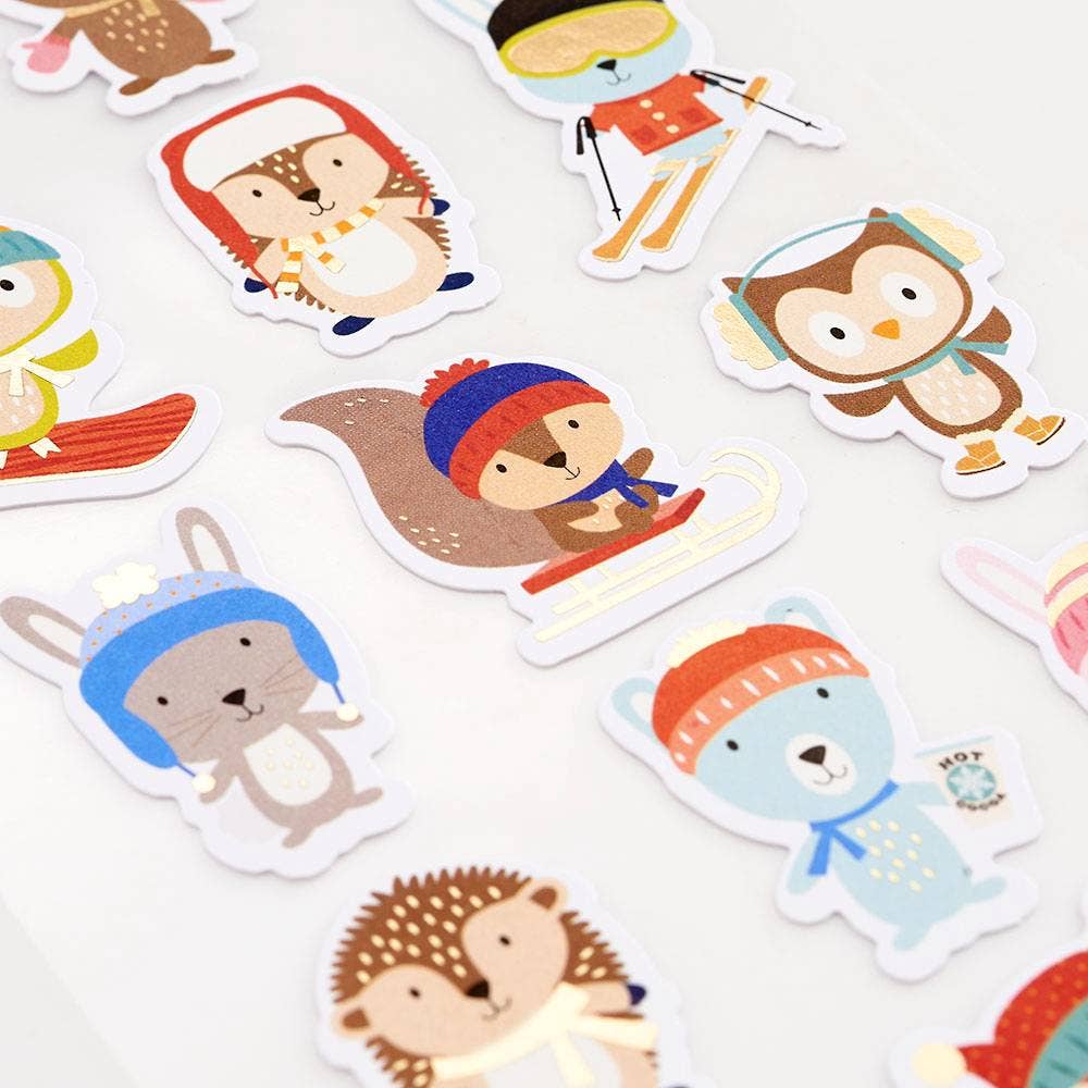 Set of cartoon animal stickers with winter accessories on a white background