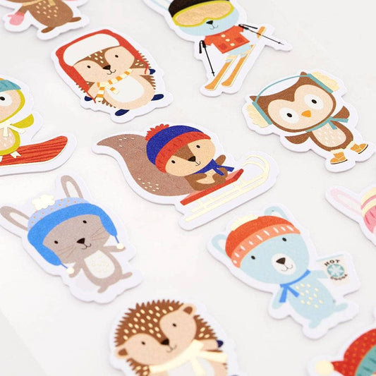 Set of cartoon animal stickers with winter accessories on a white background