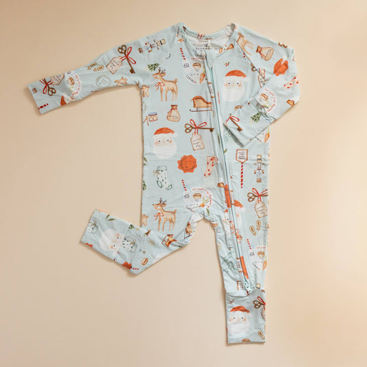 Children's onesie with Christmas-themed pattern on a beige background
