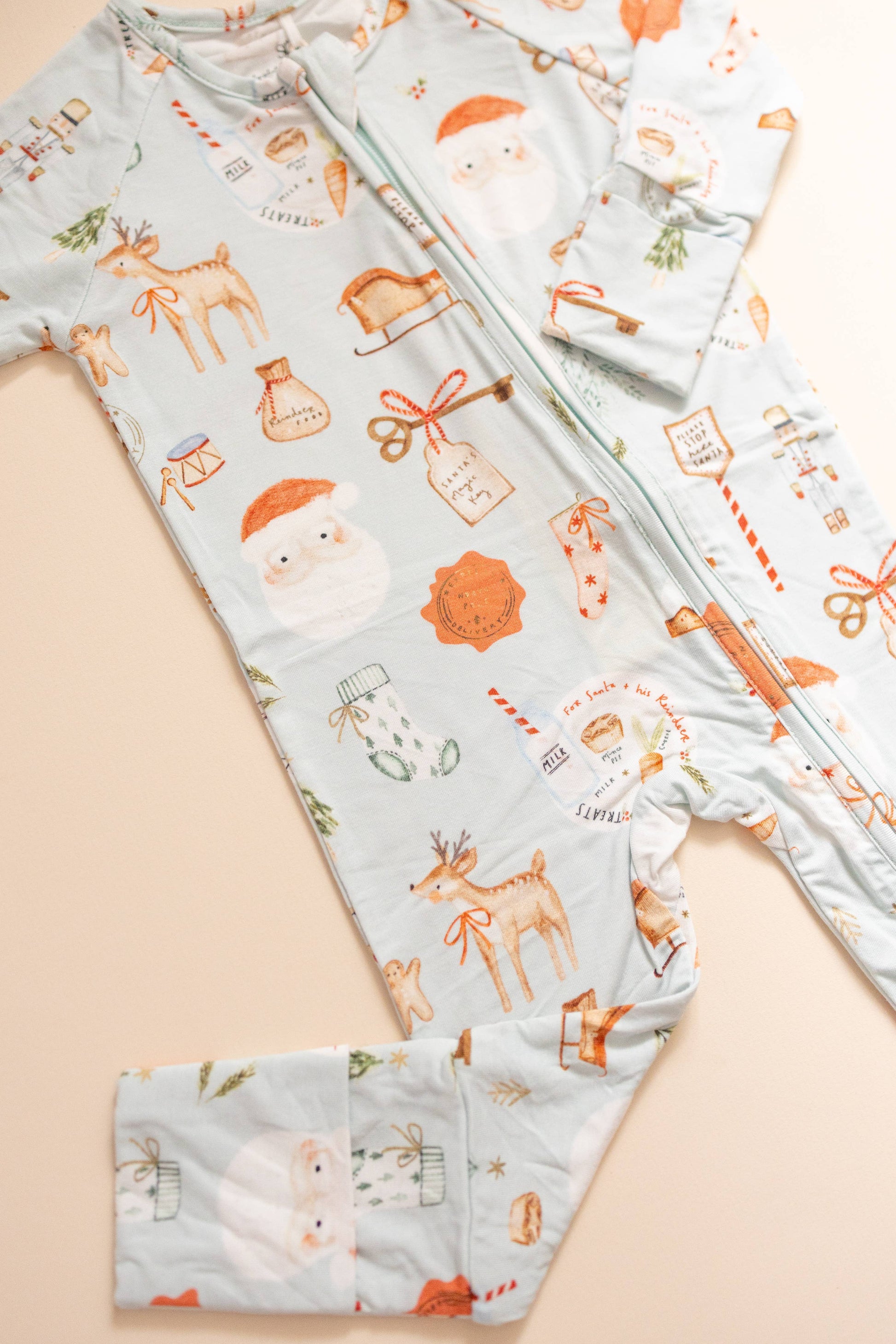 Baby outfit with festive pattern on a beige background