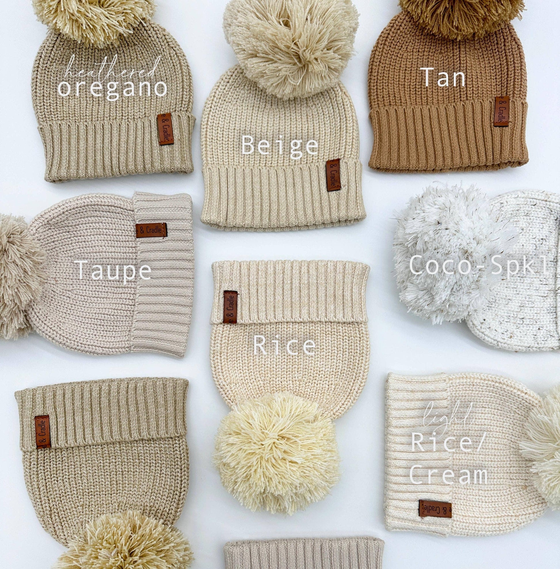 Collection of knit hats with pom-poms in various colors on a white background