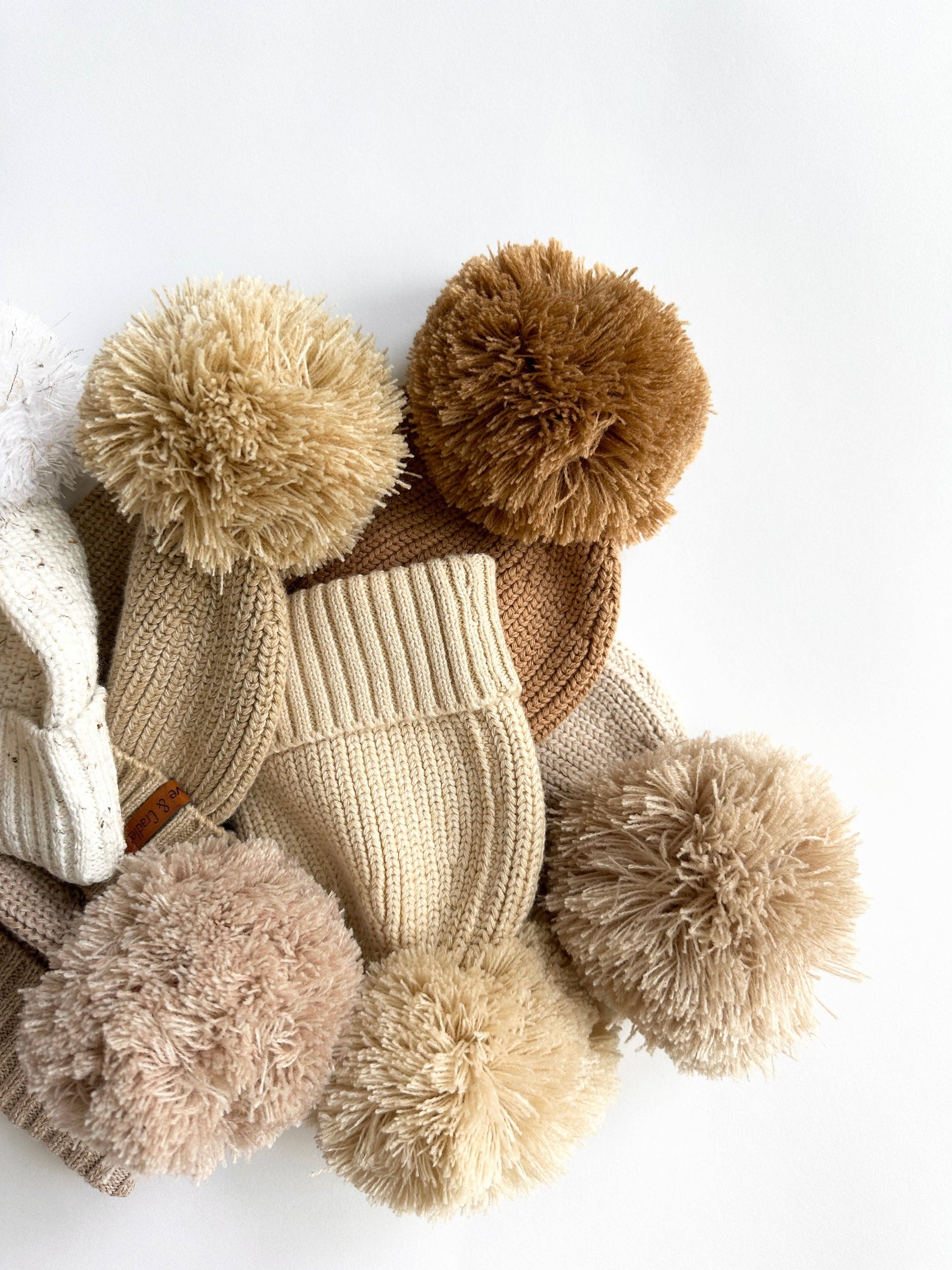 Knitted hats with pom-poms on a white background