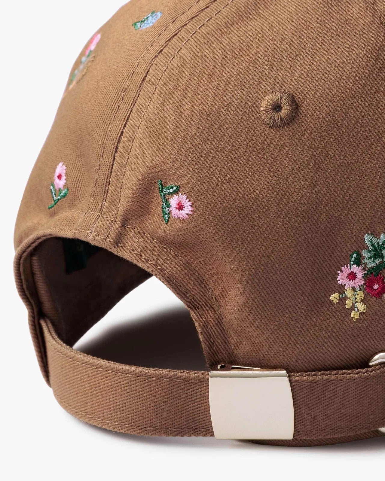 Brown cap with floral embroidery on a white background