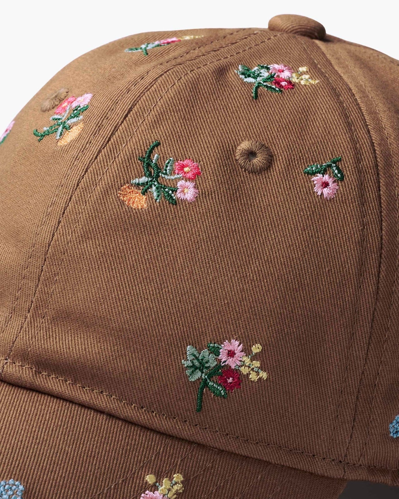 Brown cap with floral embroidery on a white background