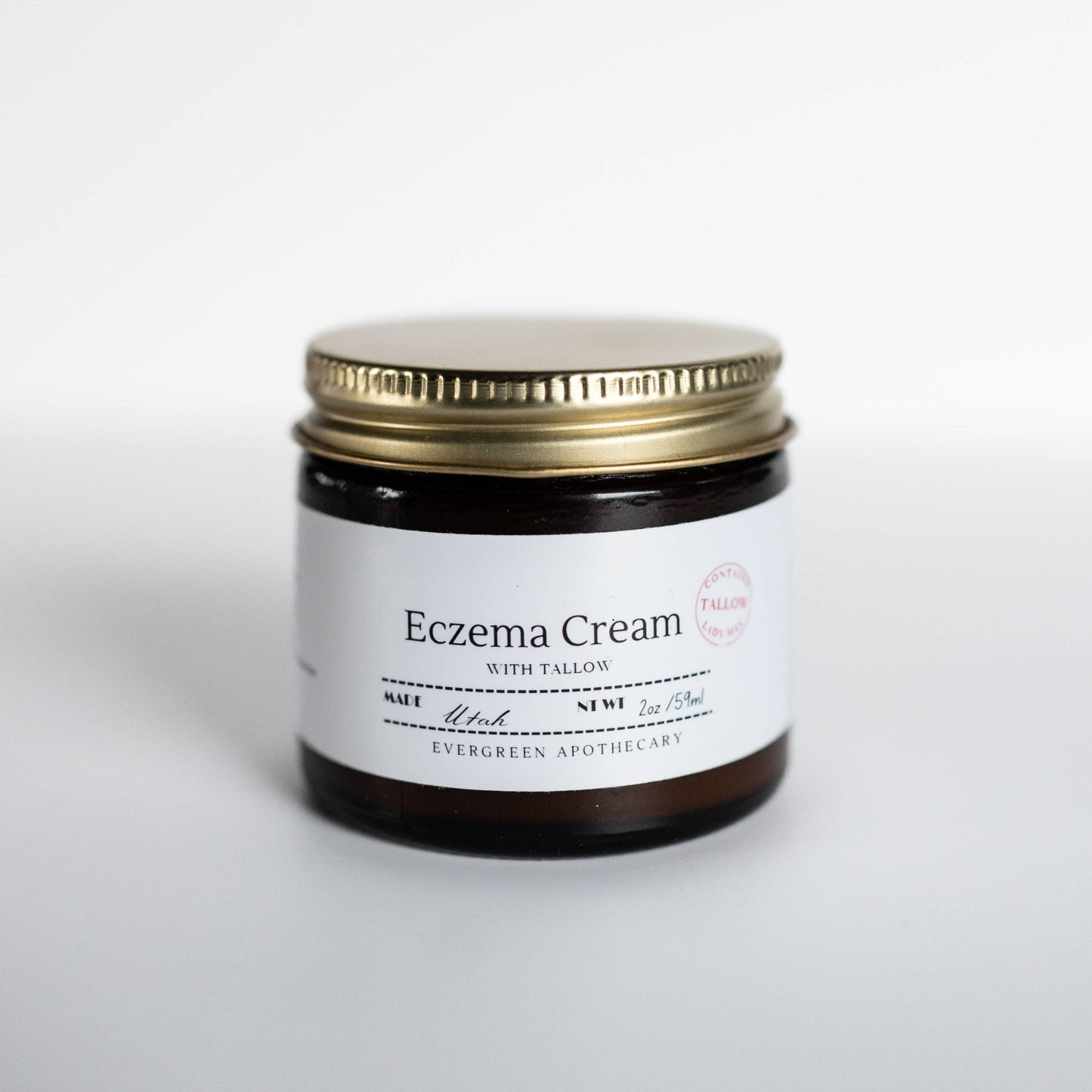 Eczema cream jar with gold lid on a white background