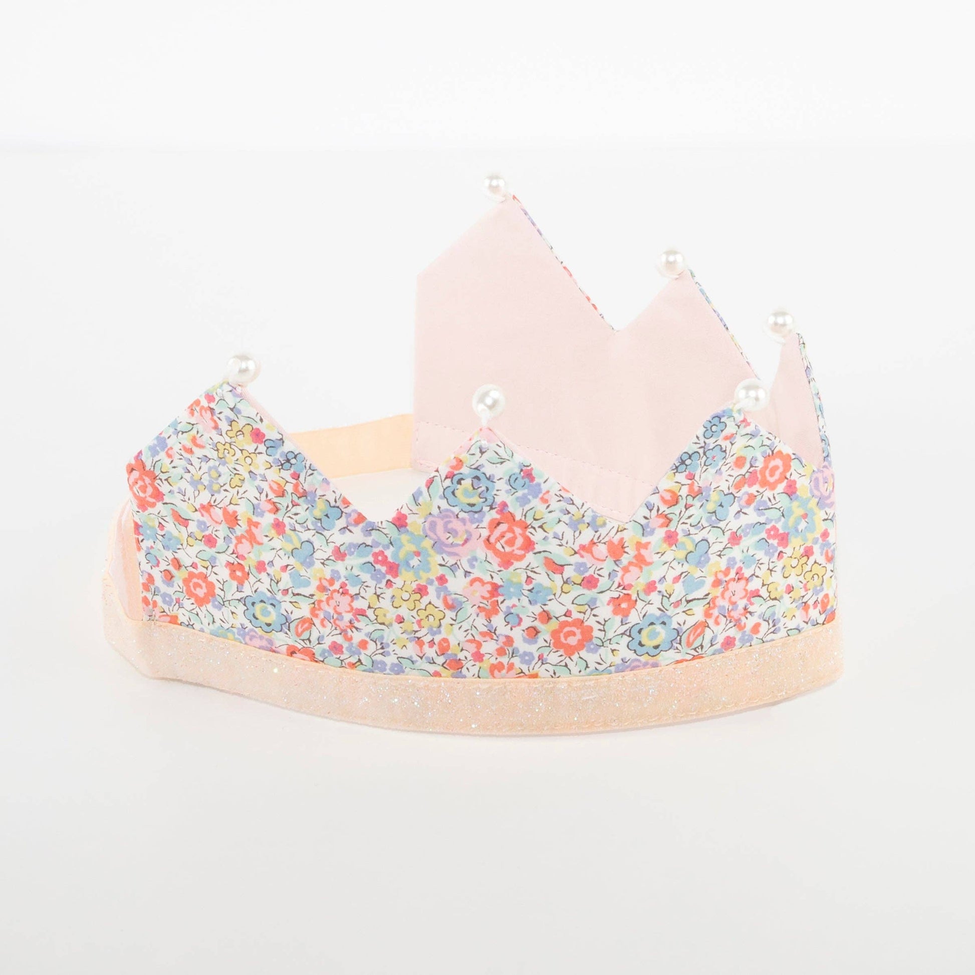 Floral-patterned crown on a white background