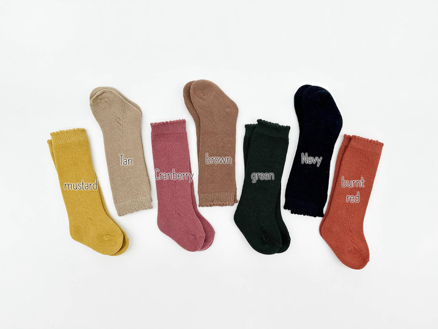 Set of colorful socks labeled with color names on a white background