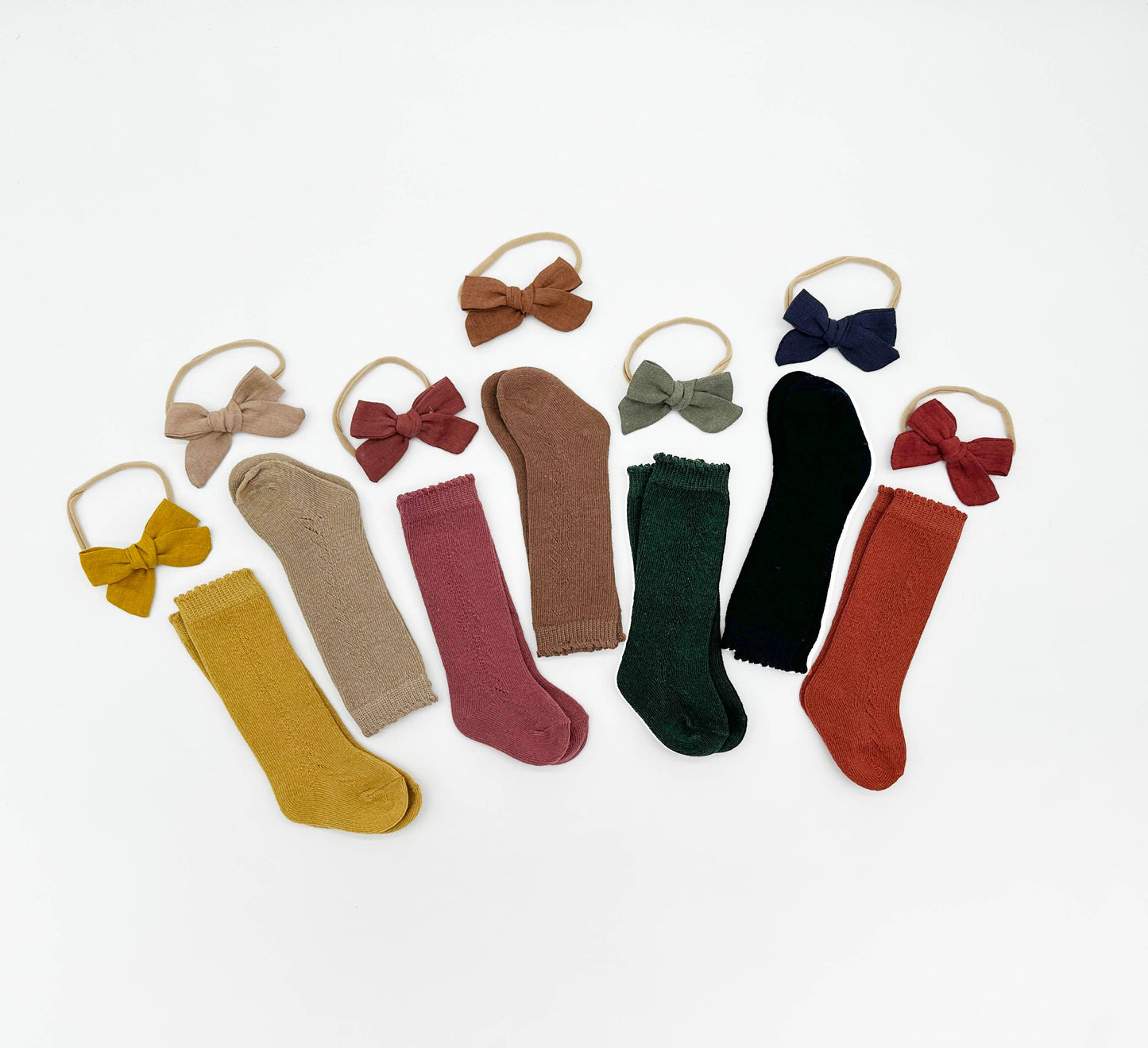 Set of colorful socks and hair bows on a white background