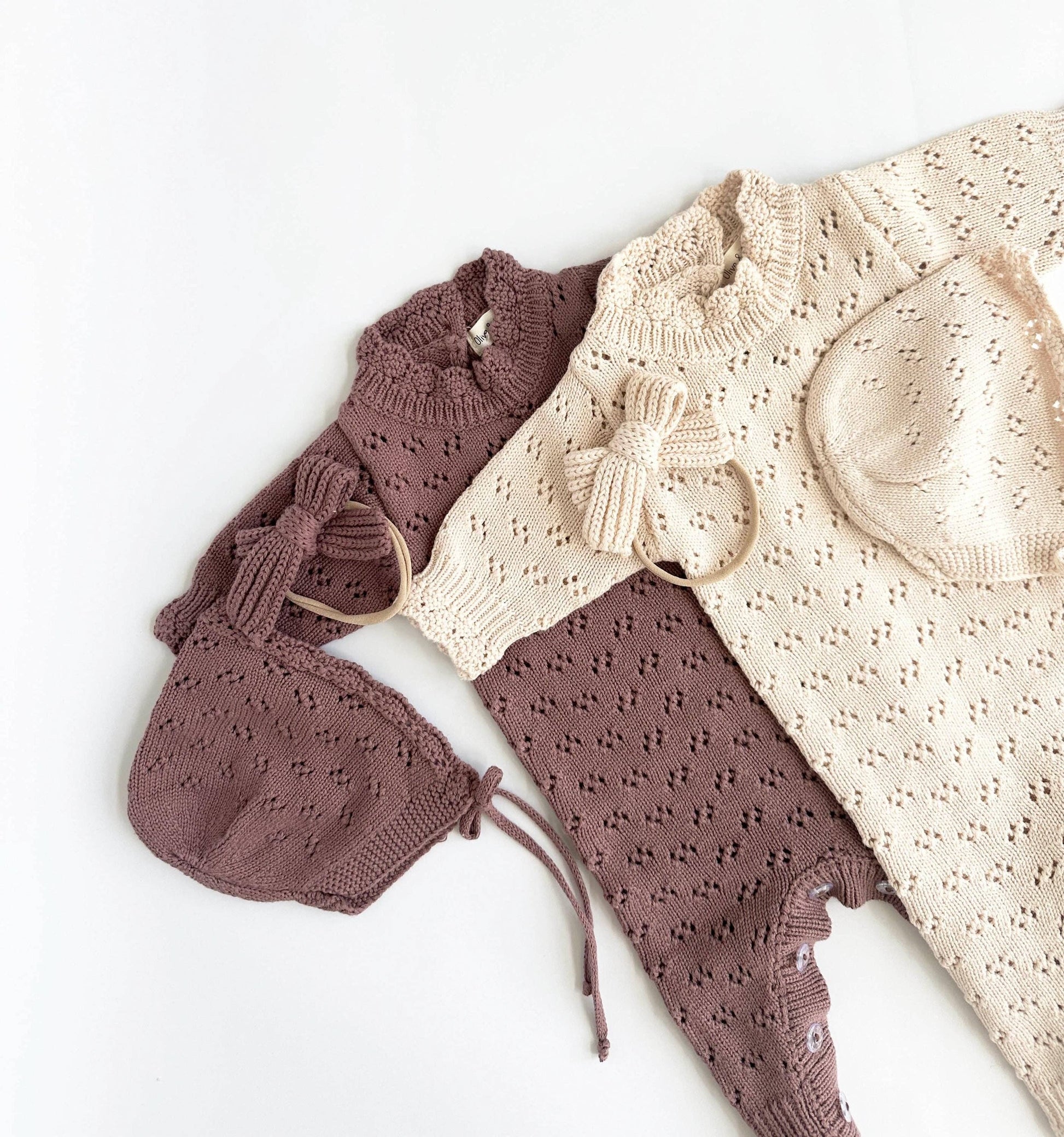 Pair of brown baby pants with a matching headband on a white background